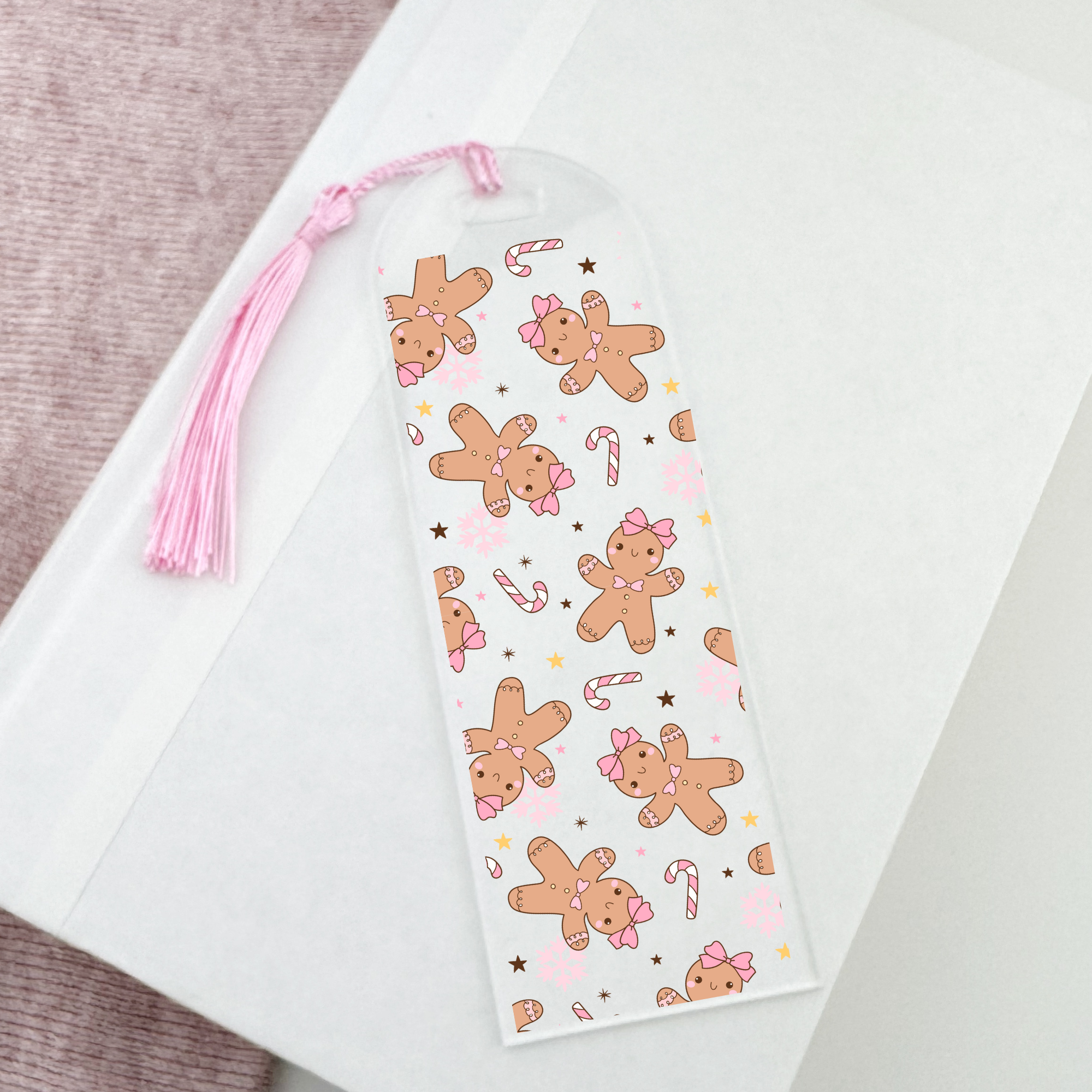 Bookmark with gingerbread with bows design on a white surface