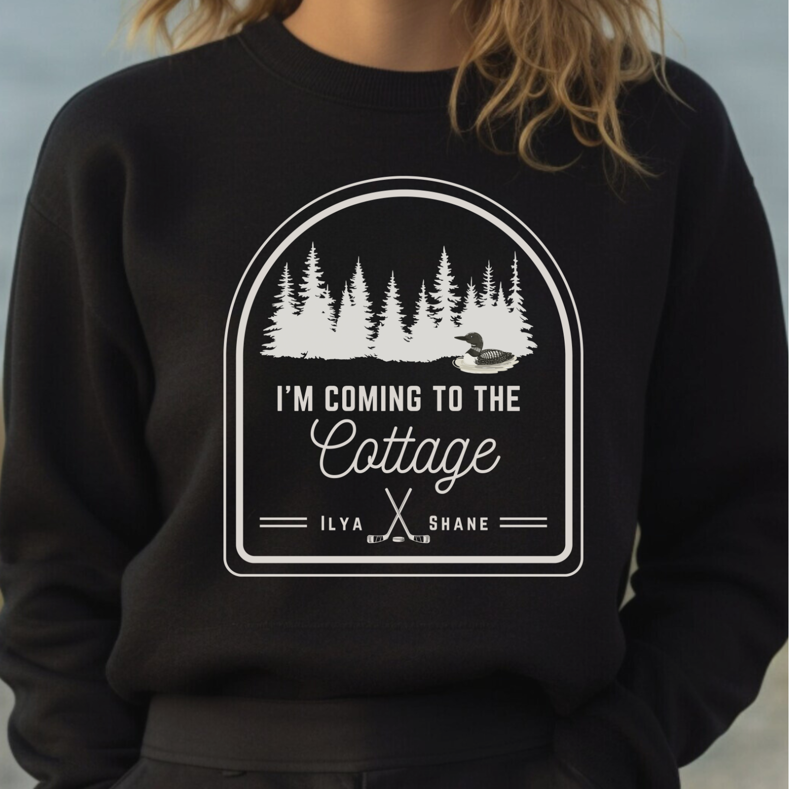 Black sweatshirt with a white graphic and text on a blurred background