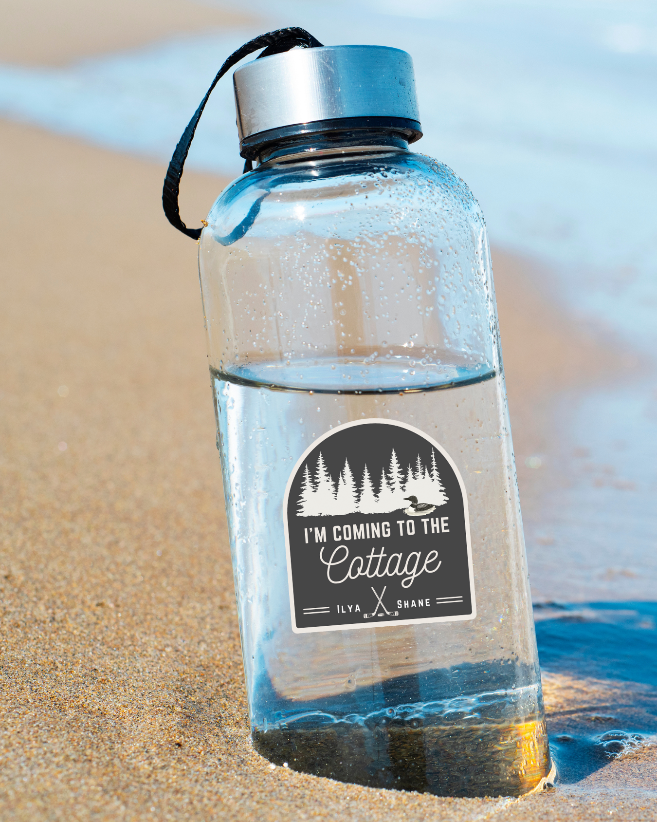 Clear water bottle with sticker "I'm coming to the cottage"