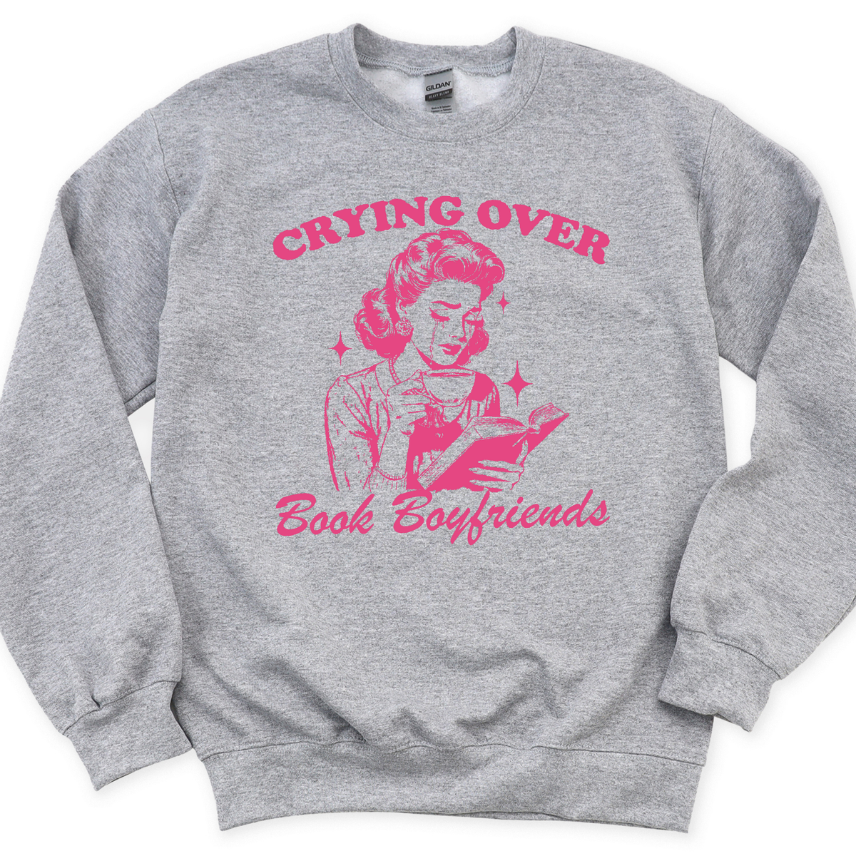 Gray sweatshirt with pink graphic and text 'Crying Over Book Boyfriends' on a white background