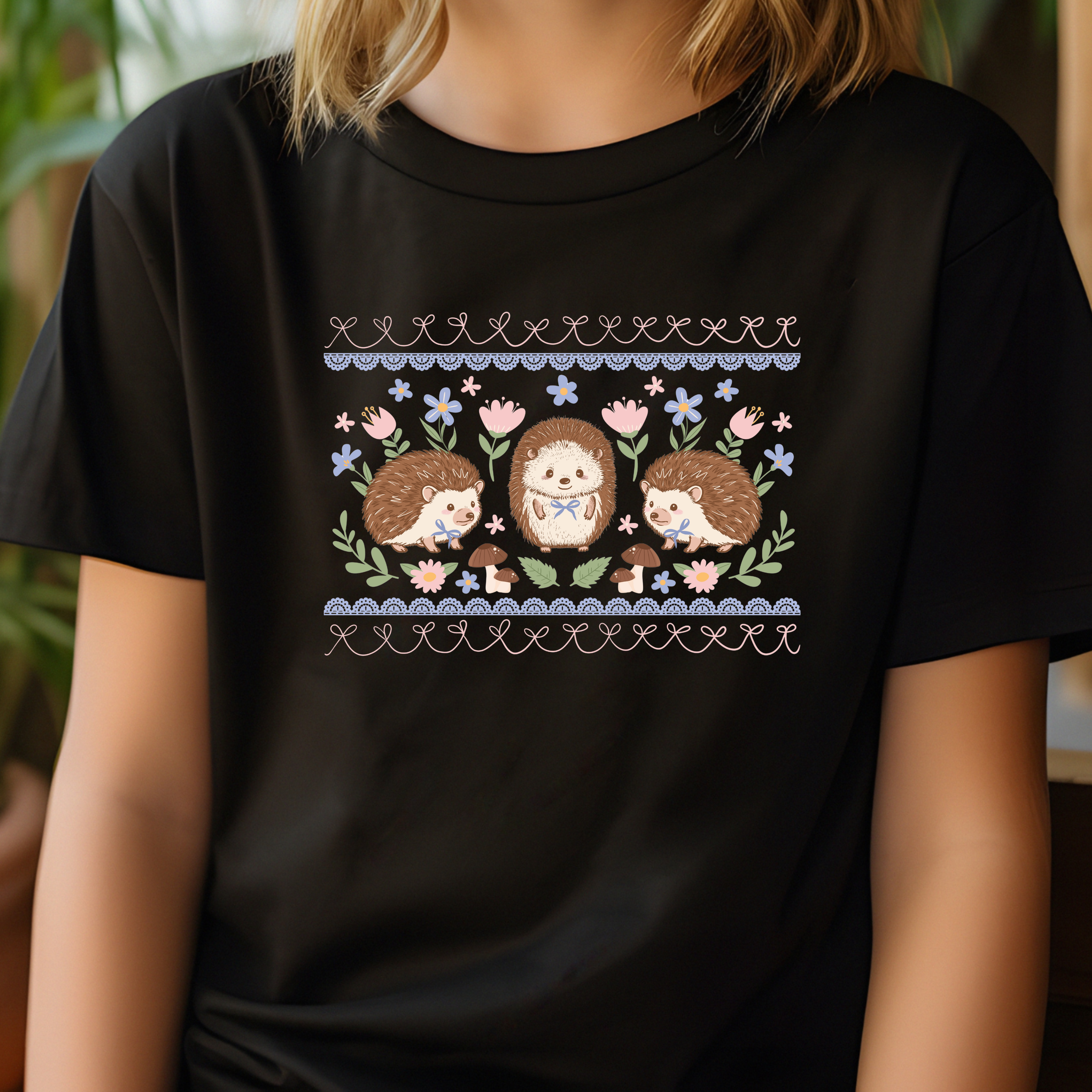 Black t-shirt with hedgehog and floral design worn by a person