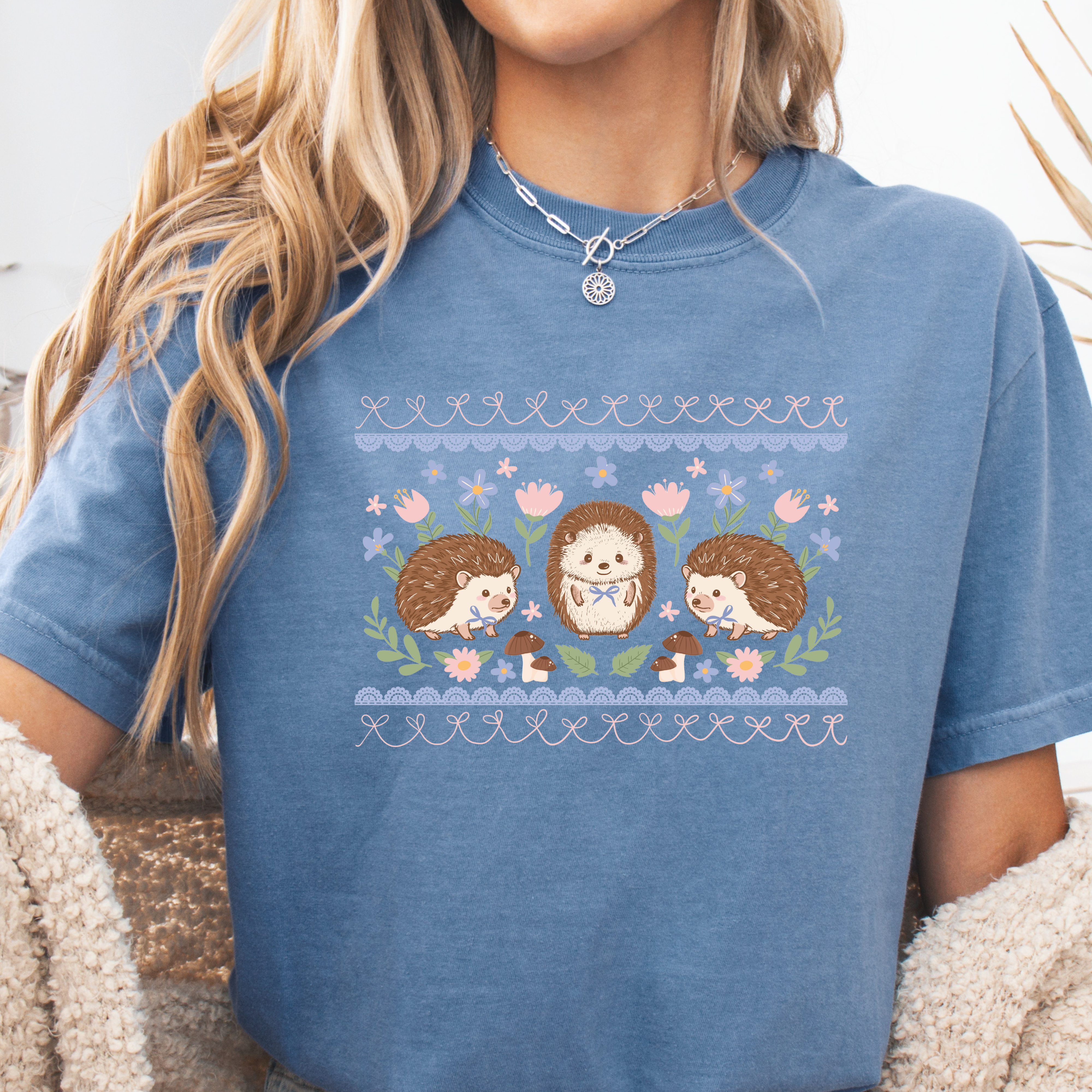 Person wearing a blue t-shirt with hedgehog design