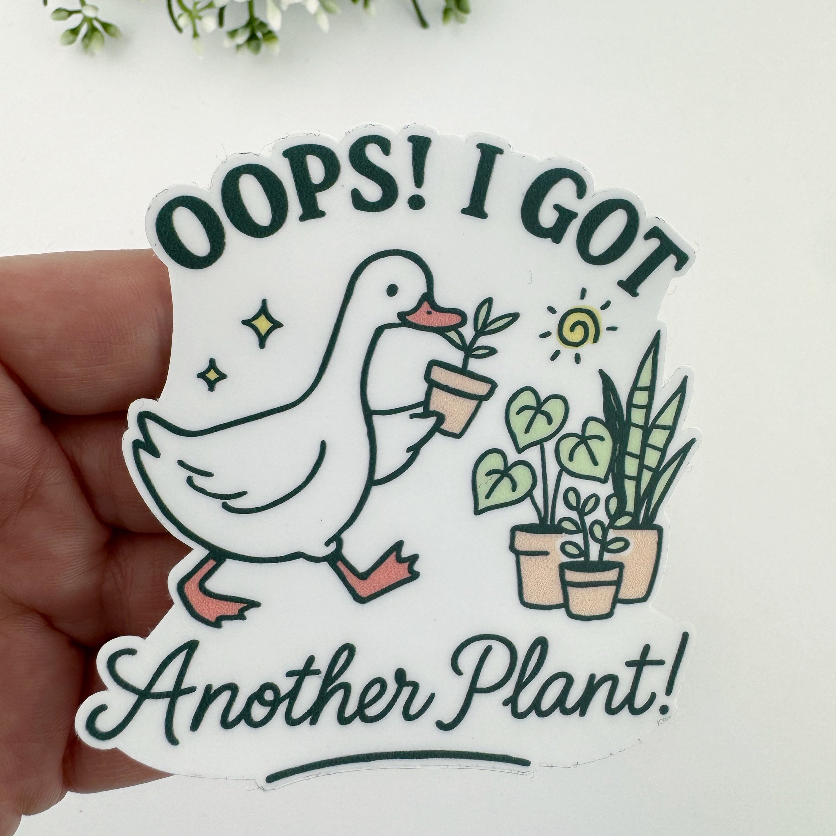 Sticker with a duck holding a plant and text 'Oops! I got another plant!'