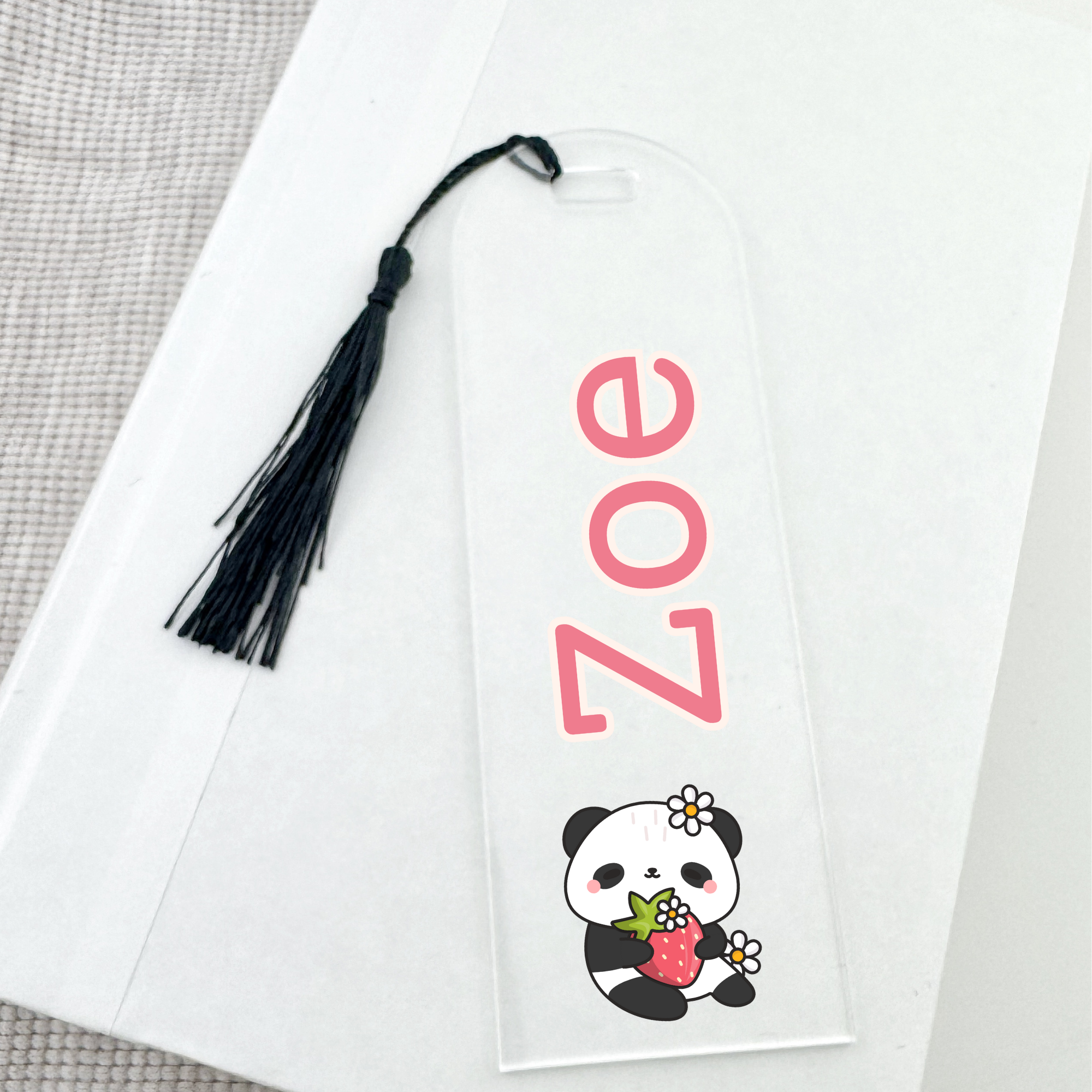 Personalized bookmark with a panda design and black tassel.