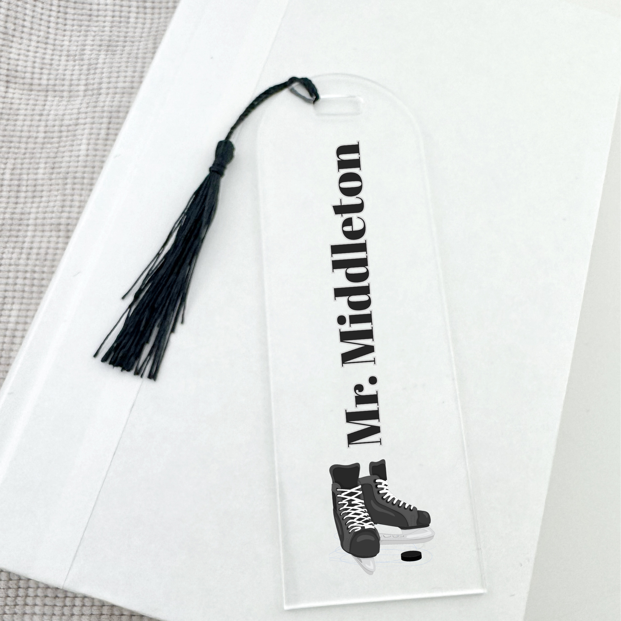 Personalized bookmark with tassel and ice skates design on a white background