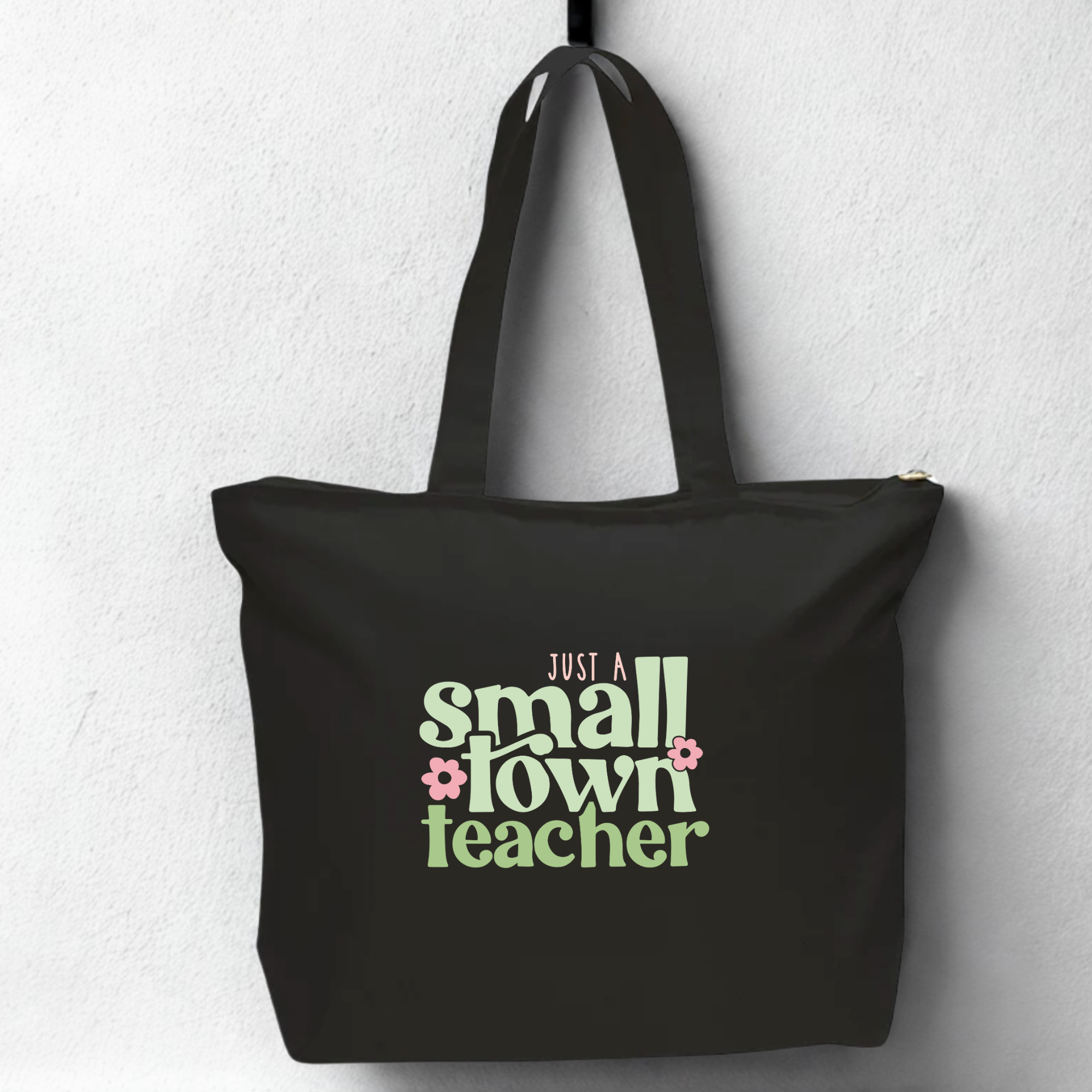 Black oversized sipper tote bag with 'Just a Small Town Teacher' text on a white background