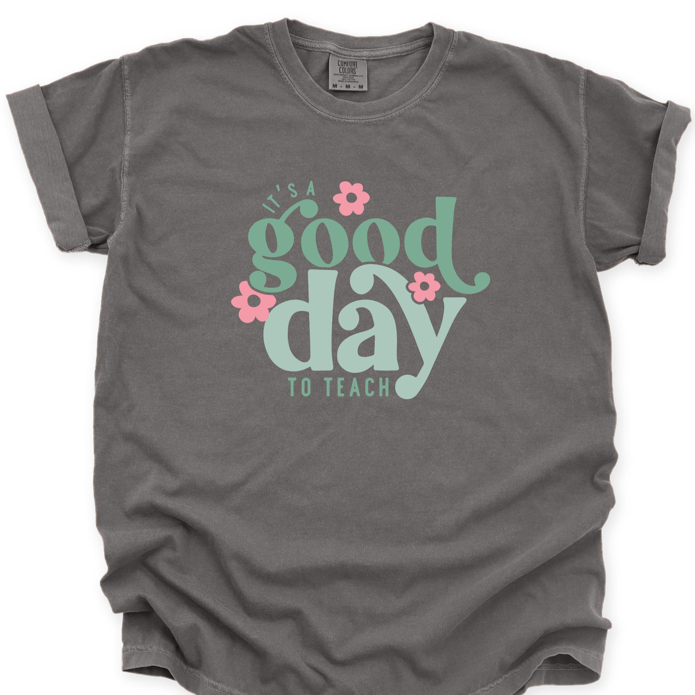 Gray t-shirt with 'It's a good day to teach' text and flowers on a white background