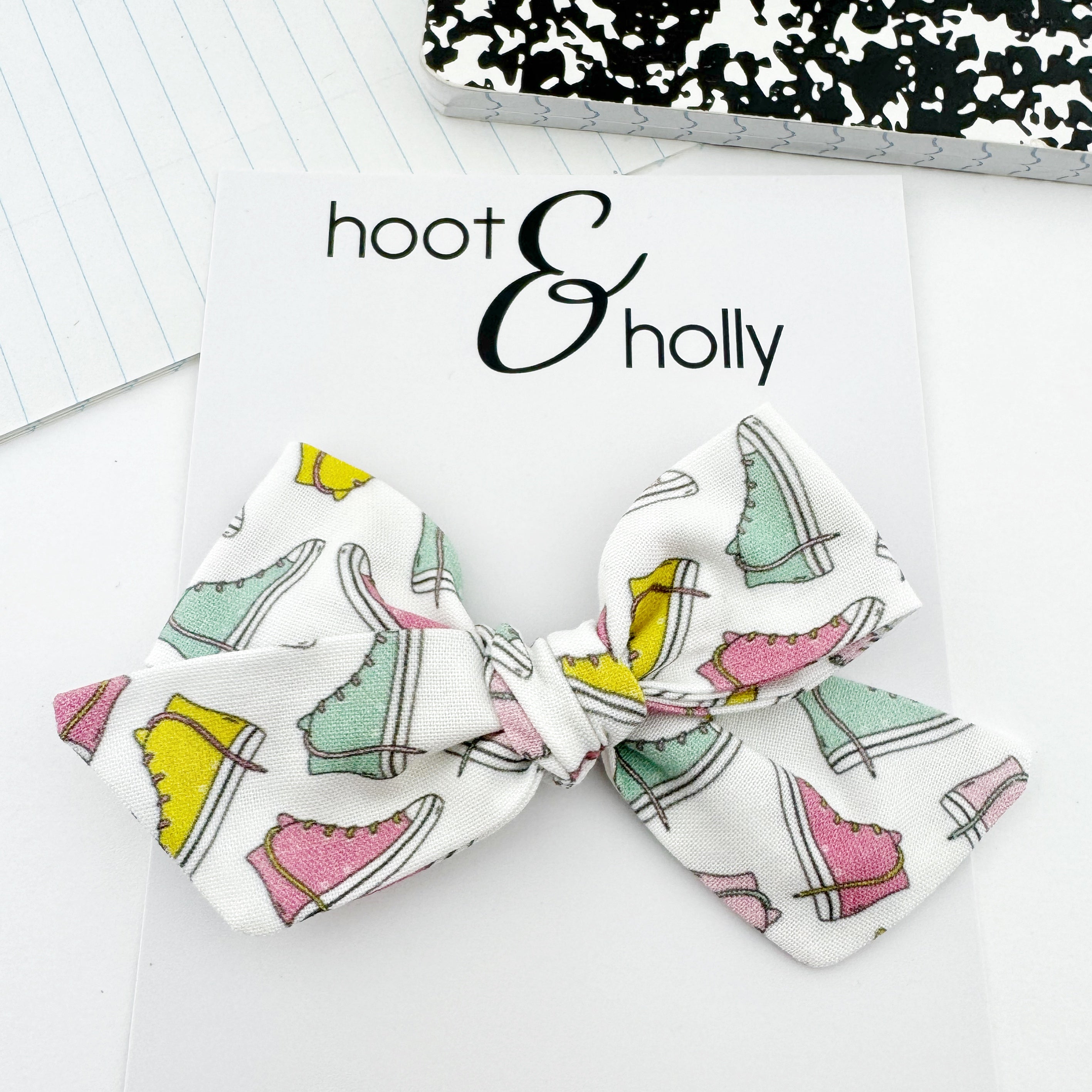 Hand-tied girls hair bow with converse sneaker print. 