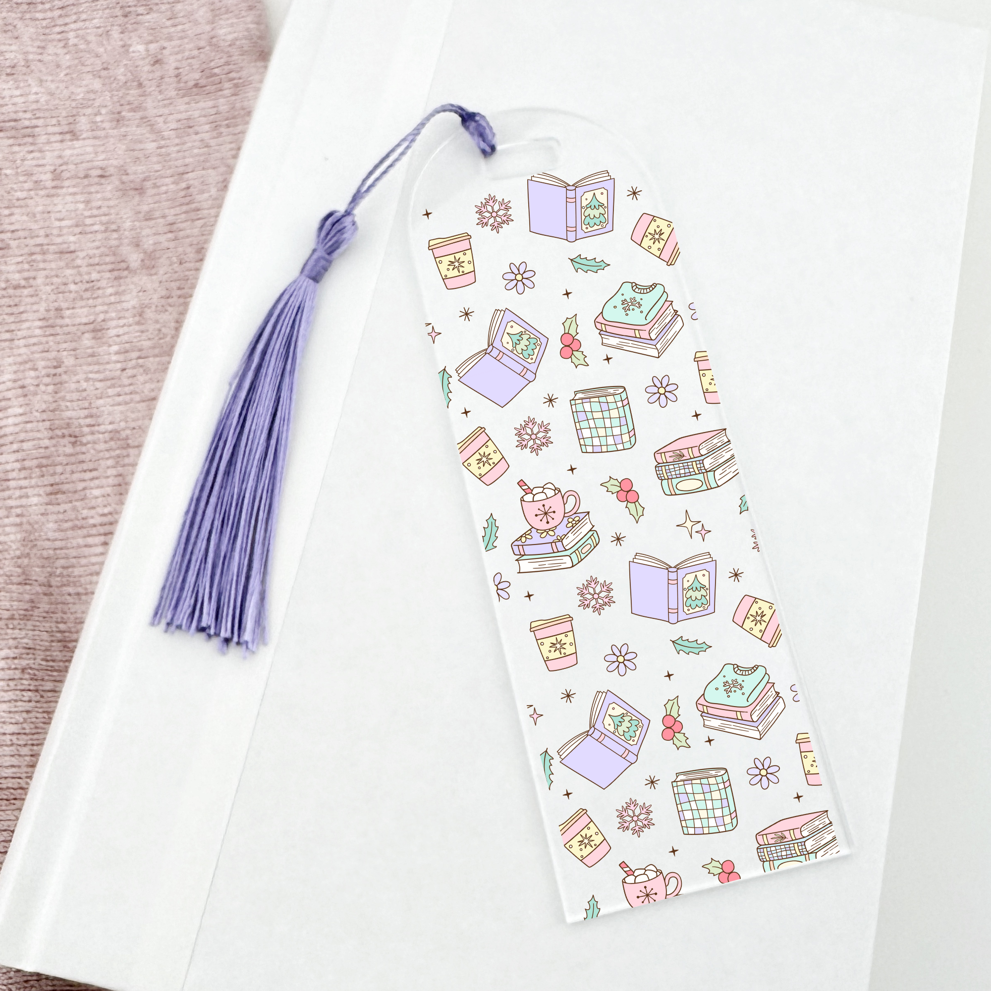 Bookmark with book-themed winter illustrations and a purple tassel on a white background