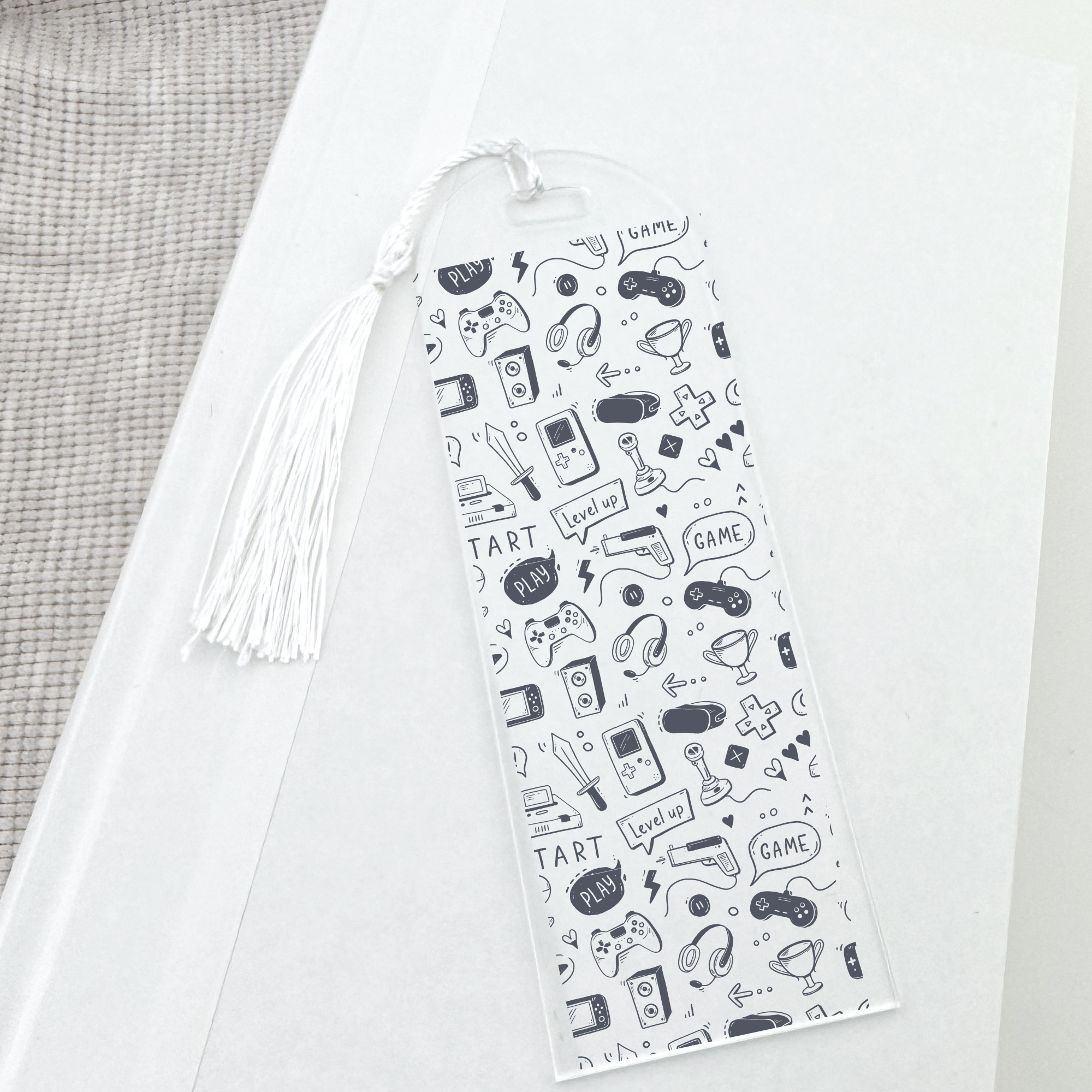 Clear bookmark with gaming-themed illustrations on a white background