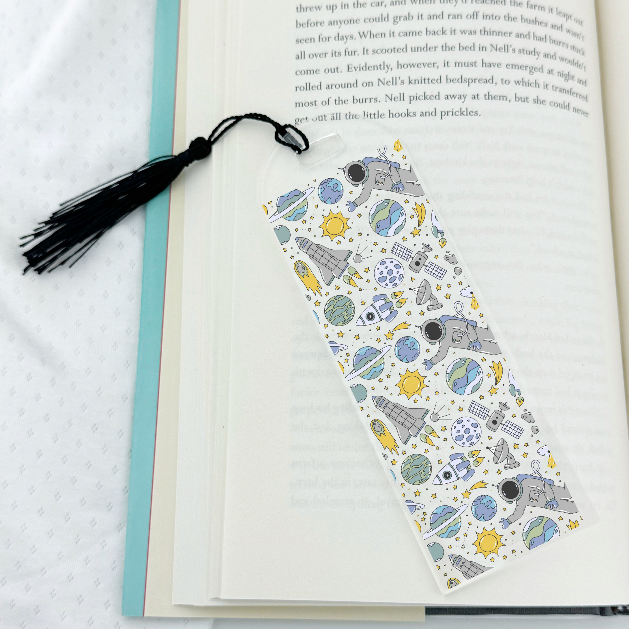 Bookmark with space-themed design on an open book