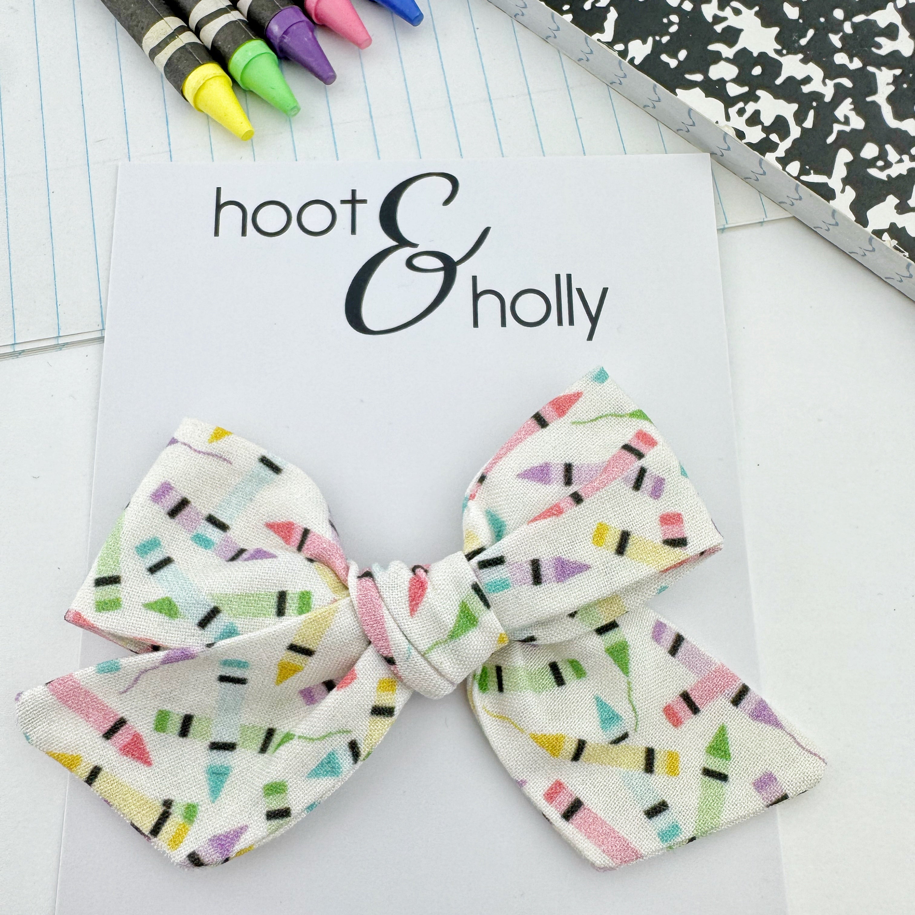 Hand-tied hair bow with crayon pattern for back to school.