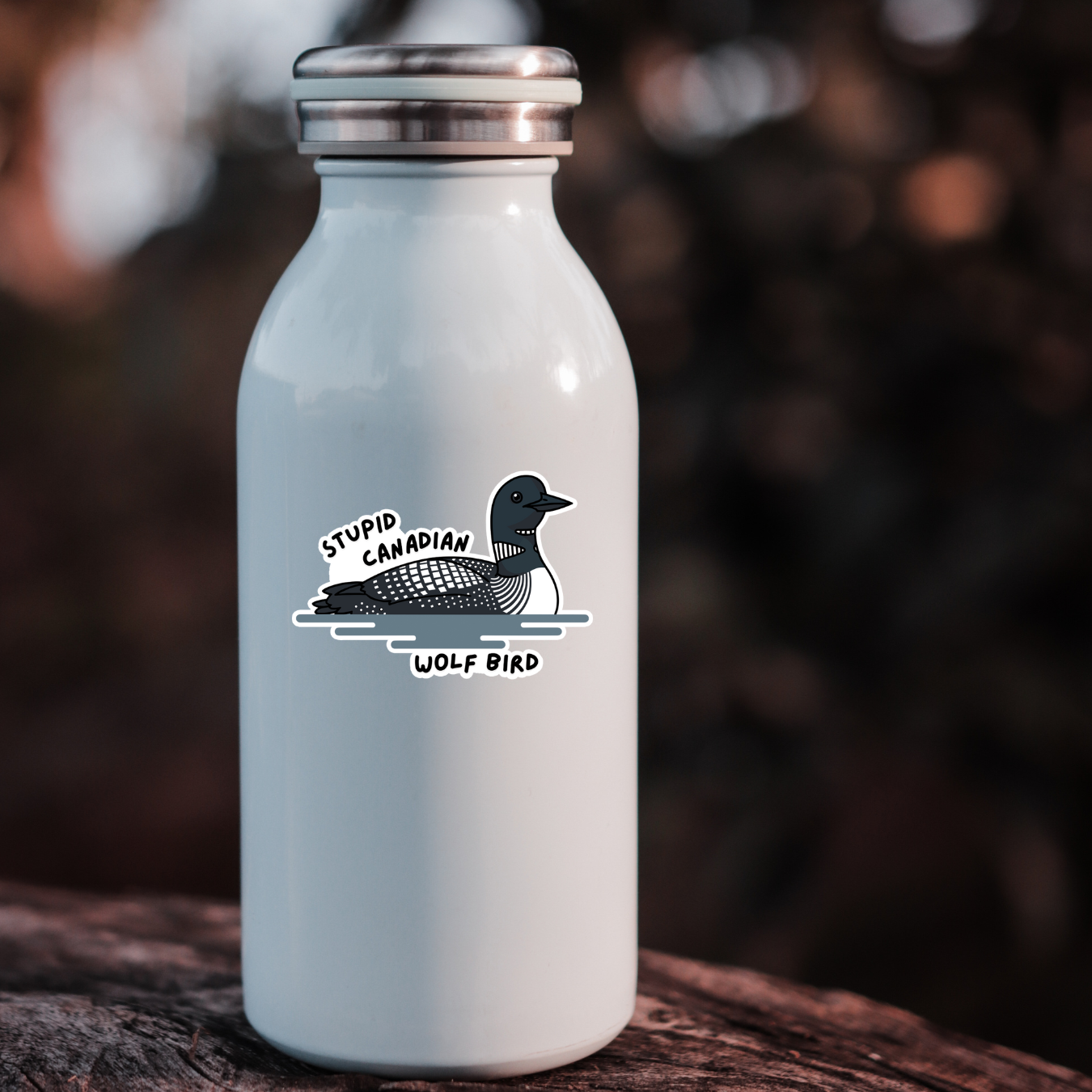 White bottle with a sticker "stupid Canadian Wolf Bird"